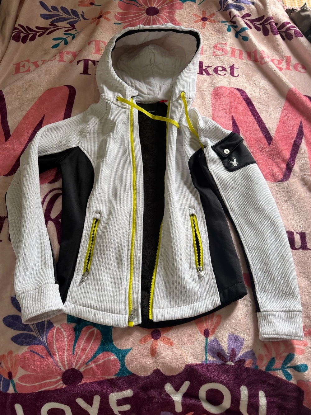 Spyder hoodie features a distinct white ribbed fabric with neon green